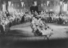 VE-Day party for the children of North Town, ready for their tea in St. Augustine’s Church Hall. The tables are arranged in a “V for Victory”, and at the back is the Mayor with the party organisers.